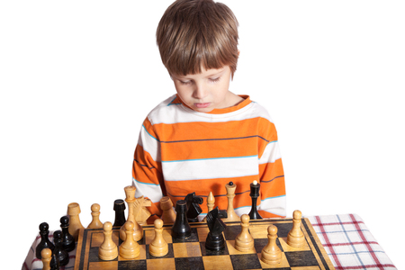 Portrait of a little boy playing chessの写真素材