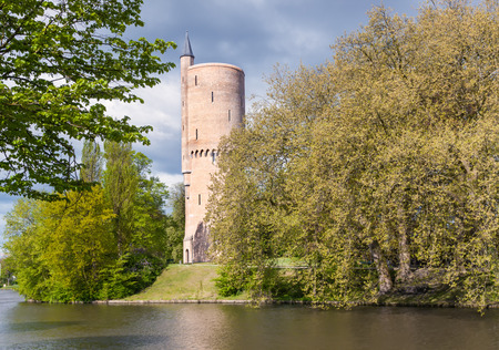 tower over the pond in the park of Bruges, Belgiumの写真素材