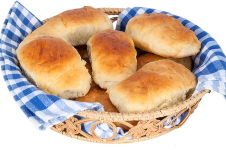Baked pies stuffed in a wicker pottle isolated on white backgroundの写真素材