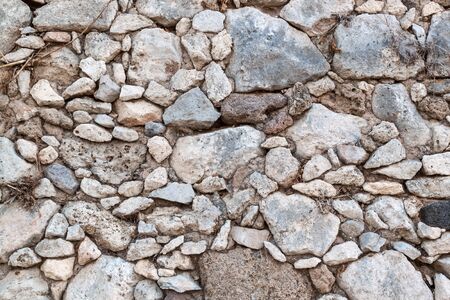 old masonry of rough stones held together with a solutionの写真素材