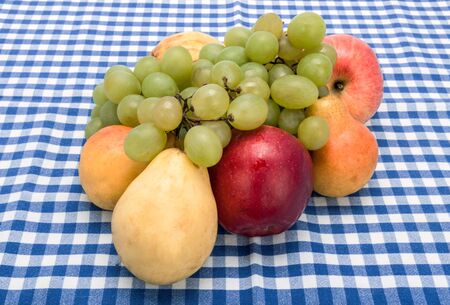 still life of fruit lying on a checkered tableclothの写真素材