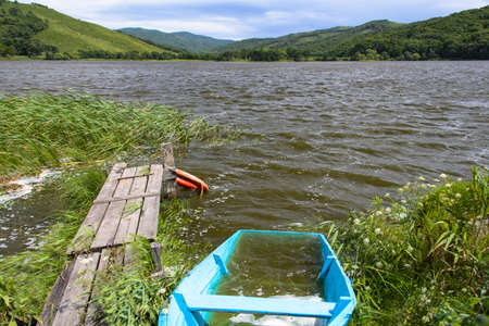 Flooded boat on the lake.の写真素材