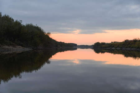 Sunrise over the river. Early morning, the silence, the water surface, the reflection in the water.の写真素材
