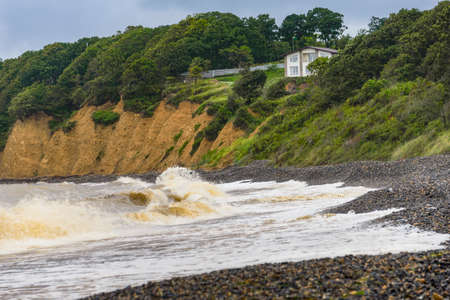 Waves after a storm. The waves rolled ashore and breaking on the rocks.の写真素材
