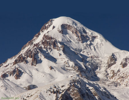 The peak of Kazbek in winter. View from Stepantsminda village, Georgia.