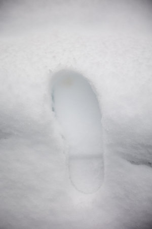 One mans footstep on the fresh friable snow footprint of a shoe in the snow