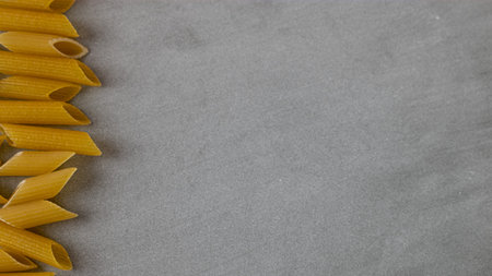 Penne Rigate Pasta Gluten free. gray background. banner