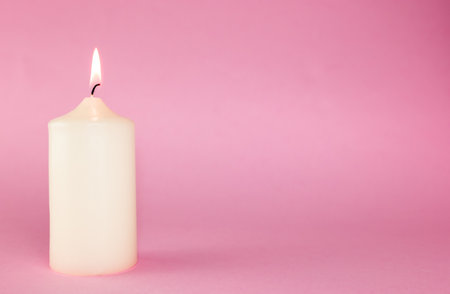 white candle on the pink background, copy spase, conceptの写真素材