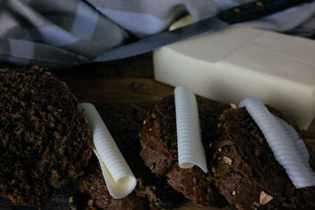 Slices of brown bread and butter. Toned image in a retro style.の写真素材