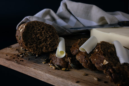 Slices of brown bread and butter. Toned image in a retro style.