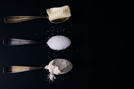 silver spoons with sugar, butter and flour, copy spaceの写真素材