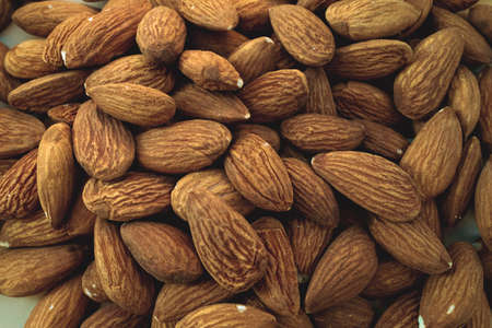 Background of big raw peeled almonds situated arbitrarilyの写真素材
