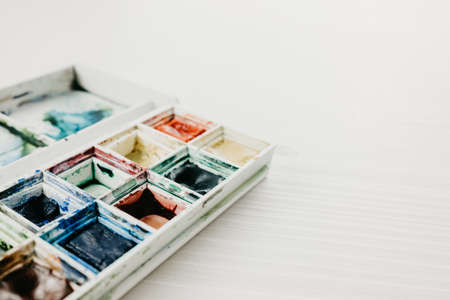 Watercolor in a box on the white background. copy spaceの写真素材