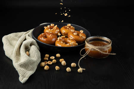 Donuts with caramel and nuts, rustic style, copy spaseの写真素材