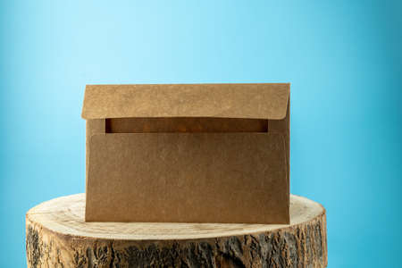 Envelope on the wooden table, blue background and copy cpaseの写真素材