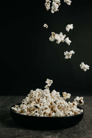 falling pop corn on black background, copy spaceの写真素材