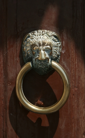 an old copper doorknocker in the form of lion s headの写真素材