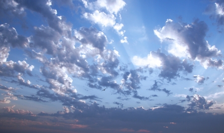 blue sky with white clouds and sunraysの写真素材