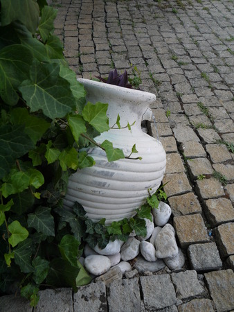old-style greek amphora laying on earthの写真素材