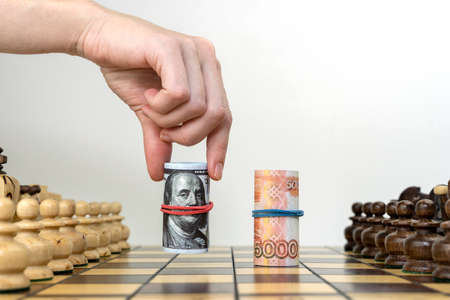 dollars and rubles on the chessboard, the concept of confrontationの写真素材