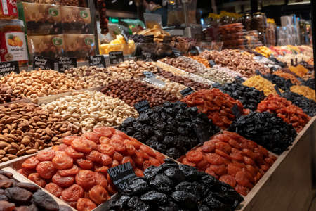 Market counter with various assorted dried fruits and nuts. Healthy food. Local market place.の写真素材
