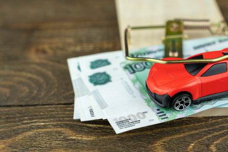 toy car in a mousetrap with money, the concept of a creditの写真素材