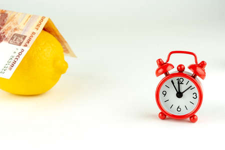 lemon, money, alarm clock and house home purchaseの写真素材