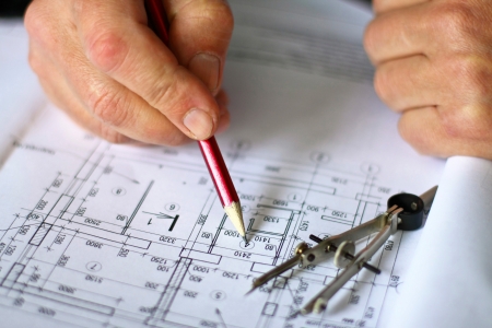 a man corrects the draft of houseの写真素材