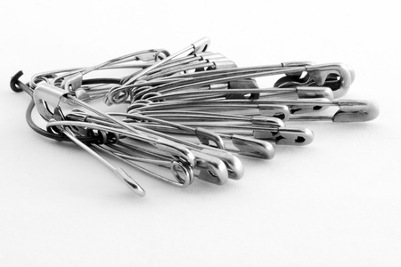 Bunch of metal gray pins on the table.の写真素材