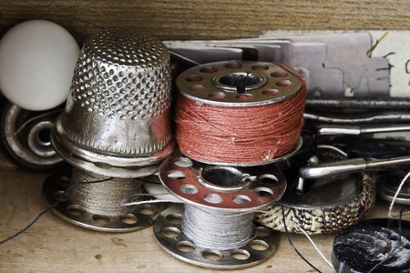Thimble,spools of thread,buttons and pins.の写真素材