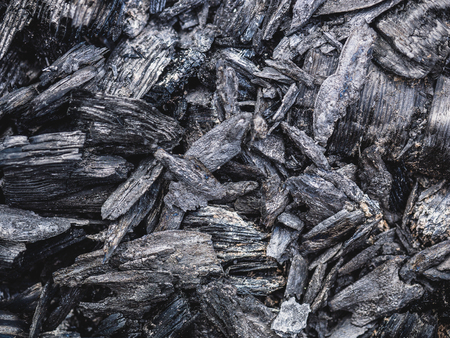 The texture of the coal left from the fire as a background hdの写真素材