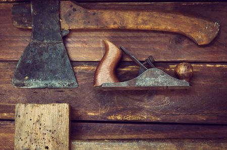 on a wooden background antique hand tool for woodworking.ax, hand saw, darwood hammerの写真素材