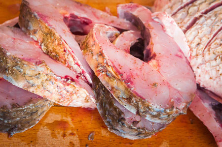 fresh raw fish with lemon on a baking tray for cooking in the oven