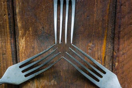 cutlery on the table, old forks on the background of old oakの写真素材