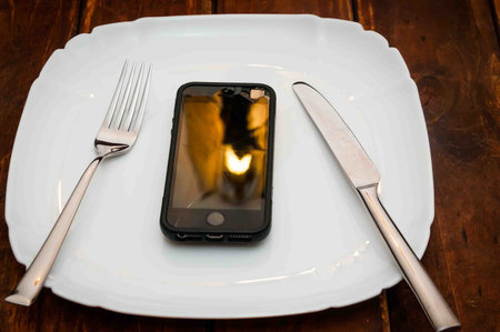 fitness bread on a plate standing on the table, fork and spoon