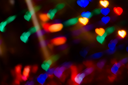 light spots in the form of hearts on a black backgroundの写真素材