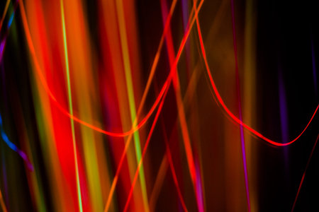 space rain, chaotic stripes of blue, green, yellow on a black background, abstraction