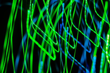 space rain, chaotic stripes of blue, green, yellow on a black background, abstractionの写真素材