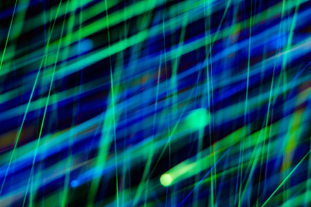 space rain, chaotic stripes of blue, green, yellow on a black background, abstraction