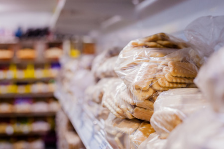 Small confectionery made of sweet pastry, chocolate coated and rectangular marmalade fillingの写真素材