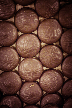 Small pastry made of sweet pastry, chocolate coated and round marmalade fillingの写真素材