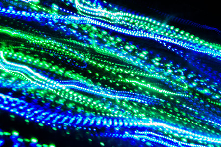 photos of the garland on a long exposure, strip lines dotted lines of different colors on a black...