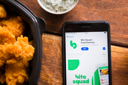 Stavropol, Russian Federation. June 10, 2019. Smartphone with mobile application Bite Sguad-Food Deliveryのeditorial素材