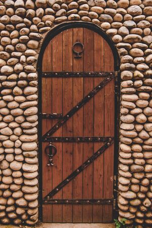 antique door made of wood and metal. entrance to the old fortress. stone structure for prayer with the Stasropol Territoryの写真素材