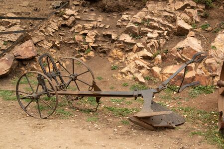 rusted old metal plow. soil treatment tool that works with the help of petsの写真素材