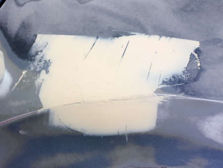 auto repair with puttyprocessing of putty with hand tools. technology for repairing paintwork on a carの写真素材