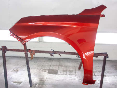 auto repair with putty.painted auto part in red.の写真素材