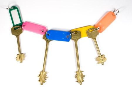 Set of old yellow keys with colored plastic babylotsの写真素材