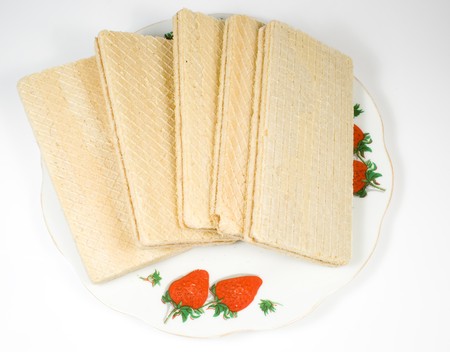 Crackling wafers with a white cream on a saucerの写真素材