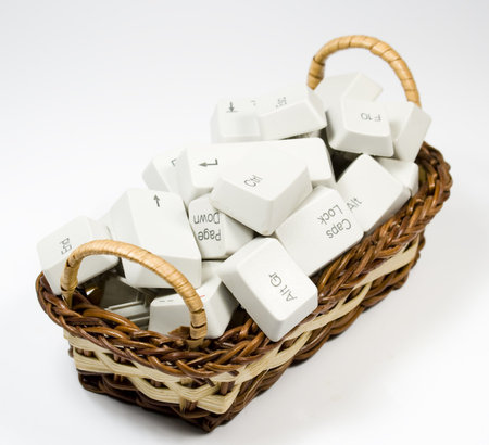 Bast basket with destroyed keyboard buttons on white